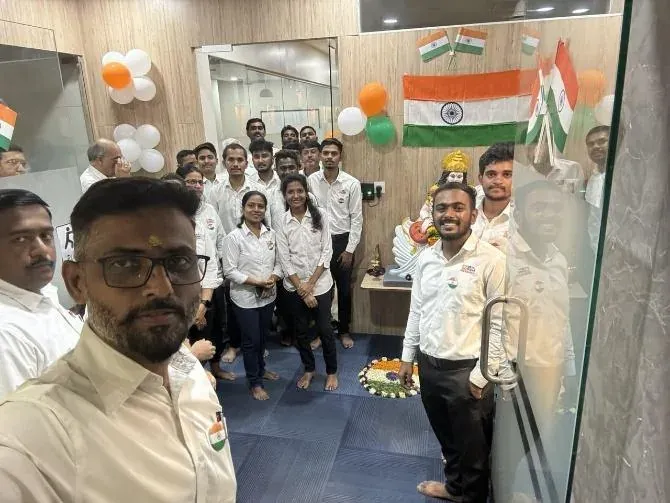 Urja-Disha employees gathered in the reception for the Republic Day ceremony, tricolour flags and balloons on the wall behind