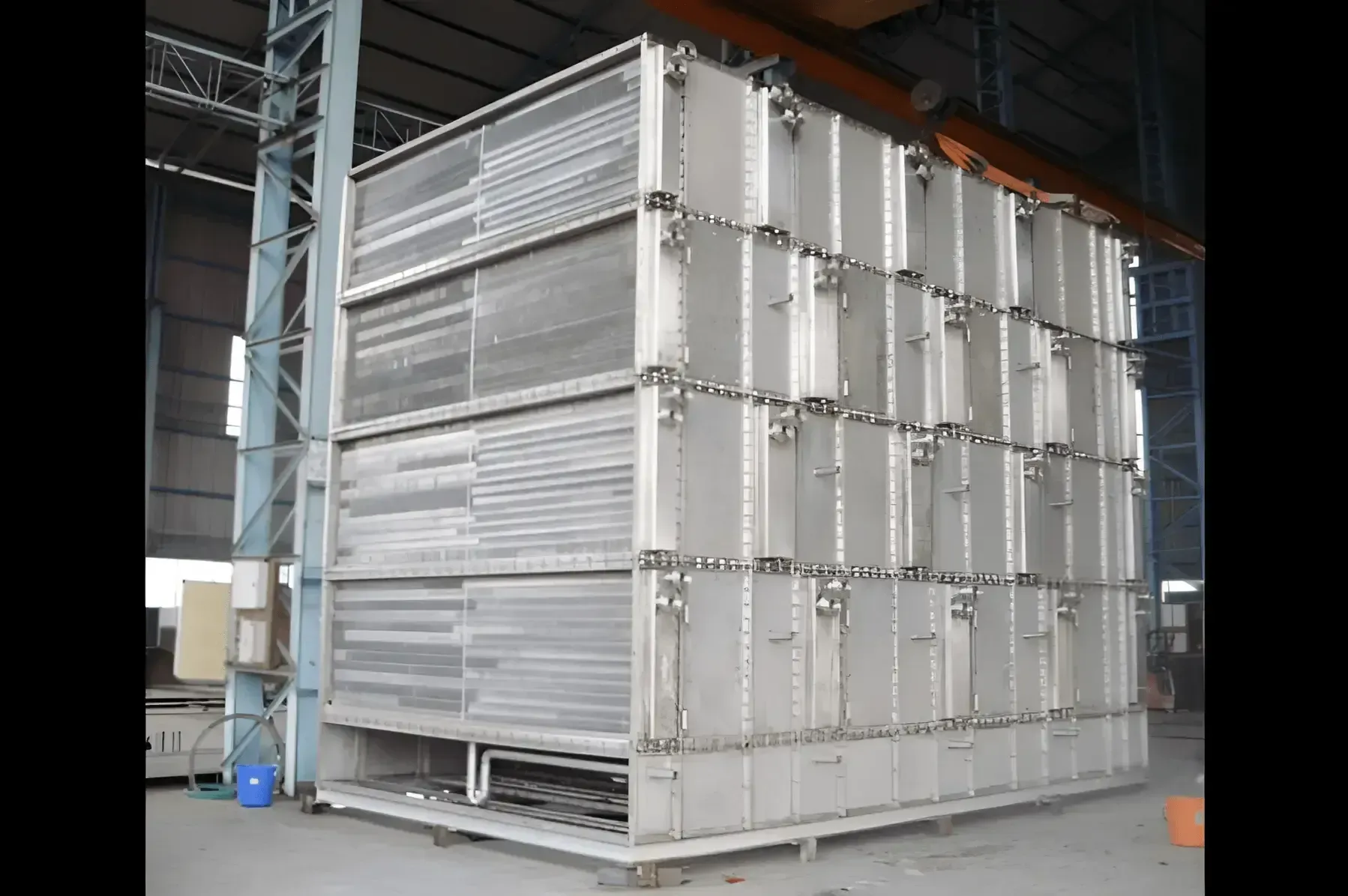 Large finned tube air preheater casing under fabrication in the workshop, overhead crane above