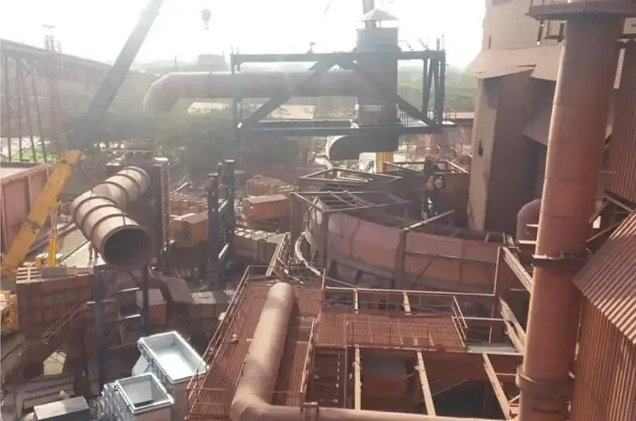 Coke drying system ducting and structural steel being erected at a steel plant, with a mobile crane lifting a duct spool