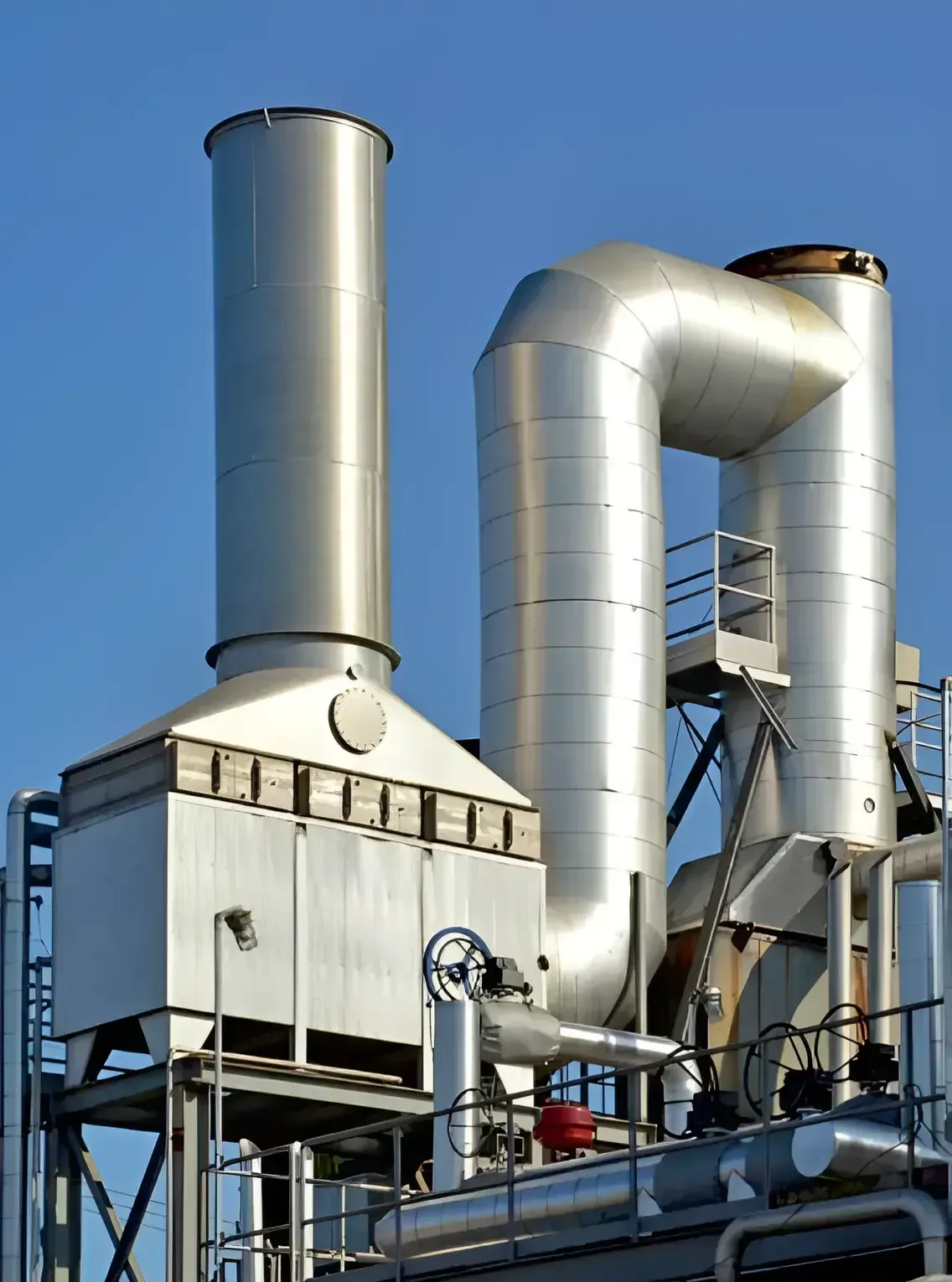 Stainless clad condensing economiser with flue gas ducting and stack against a clear sky