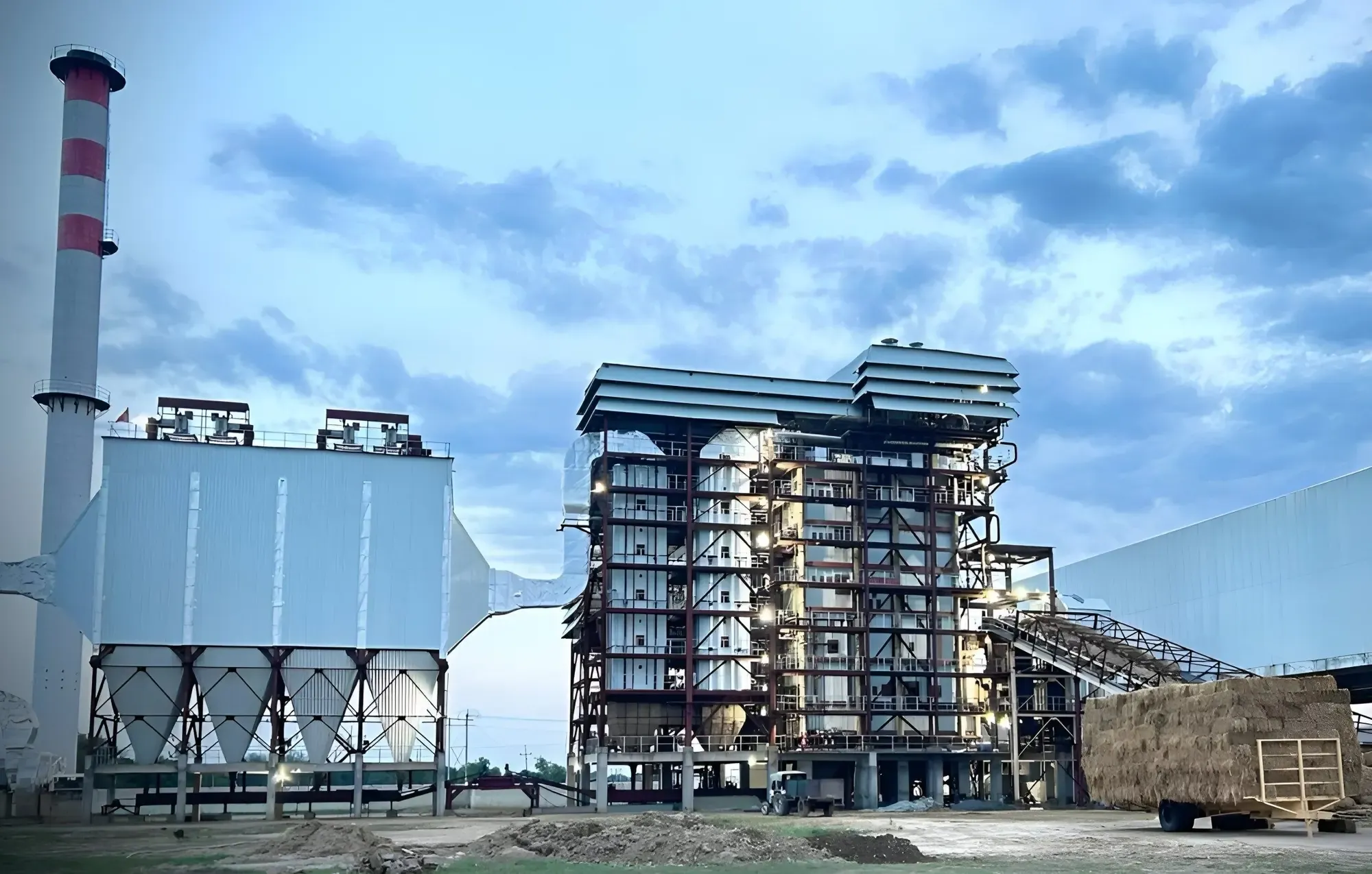 Bagasse-fired boiler and precipitator at a sugar plant at dusk