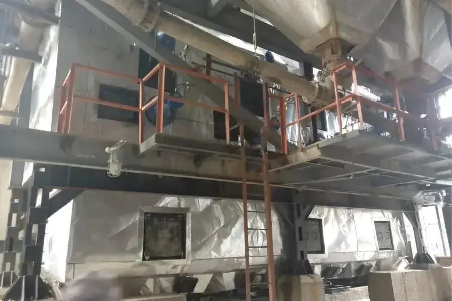 Clad waste heat recovery boiler with access platform inside a plant building